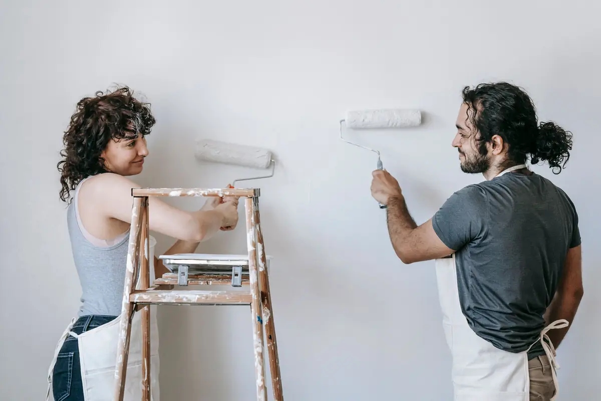 People painting a wall together — painting help in Dayton